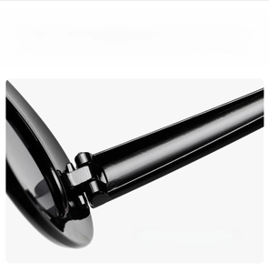 Macro detail of high-quality metal hinge structure on minimalist oval white sunglasses