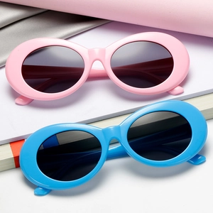 Trendy retro oval sunglasses set in pink and blue plastic frames with dark lenses