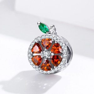 Detailed view of s925 silver orange slice charm with orange and green gemstones