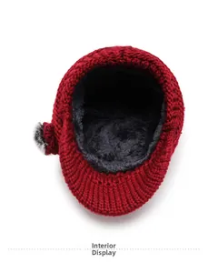 Detail view of the thick gray fleece lining inside a red knitted winter beanie for warmth
