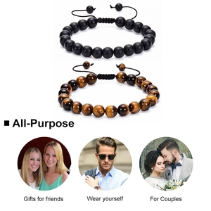 Detailed view of adjustable red tiger eye and matte black beaded bracelet set