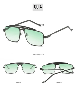 Detailed view of pilot sunglasses with green gradient lenses and black double bridge frame