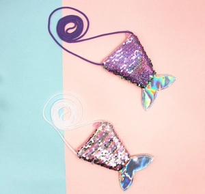 Macro detail of two mermaid tail sequin coin purses with holographic fins and lanyards