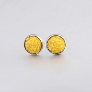 Close-up of yellow 10mm drusy stud earrings with textured surface and metal base