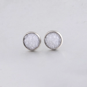 Detail of 10mm silver Drusy stud earrings with white crystal texture on gray background