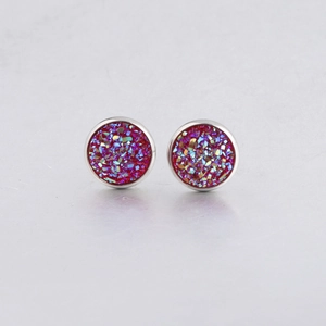 Macro view of 10mm silver stud earrings with sparkling red and purple drusy inlay