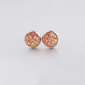 Close-up of 10mm orange drusy stud earrings with glittery resin and silver metal base