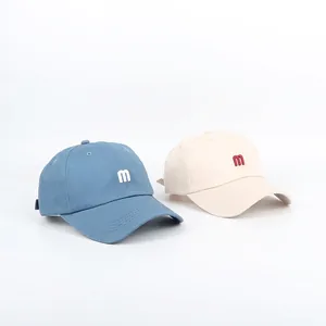 Classic baseball caps with embroidered 'm' in grey blue and beige cream colors