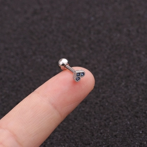 Mini heart-shaped blue zircon cartilage stud in polished stainless steel on fingertip