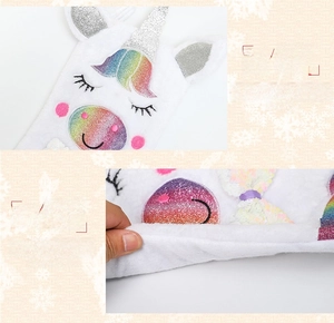 Detail of plush unicorn Christmas stocking showing soft faux fur and sequin embroidery