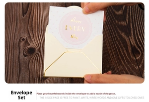Detail of cream envelope with gold edge and Happy Every Day greeting card held by hands