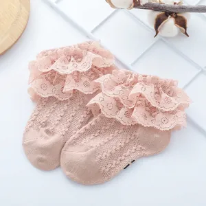 Detail of baby girl pink cotton socks with three-layer lace edges and breathable mesh knit