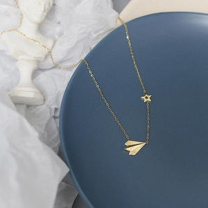14K gold plated titanium necklace featuring a paper plane and hollow star pendant