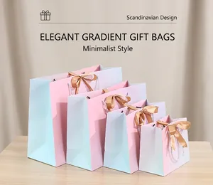 Set of five gradient gift bags with elegant gold satin bows and white woven handles