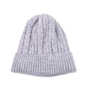 Detail shot of chunky cable knit texture and ribbed edge on light purple beanie hat