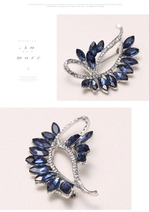Detailed macro view of dark blue marquise-cut crystal brooch with sparkling silver alloy base