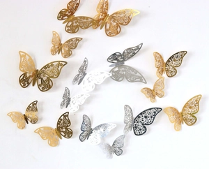 Detail of 3D hollow paper butterflies in gold and silver finish for festive wall decoration