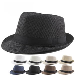 Close-up of men's summer straw fedoras with rolled brims and black ribbon bands in various colors
