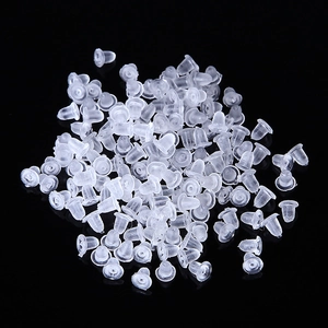 Close-up of bulk clear silicone bullet clutch earring backs on black background