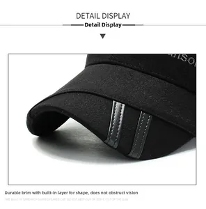 Detail view of the black wool baseball cap brim with leather stripes and firm peak