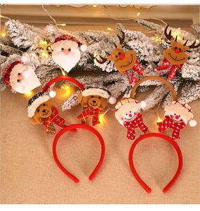 Detail of Christmas headbands featuring Santa, reindeer, and snowman in plush fabric