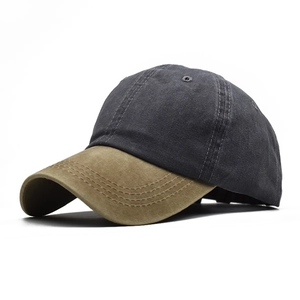 Detail of grey washed cotton baseball cap with contrast khaki brim shown from a 45-degree angle