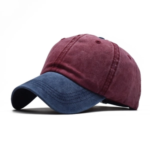 Detail of vintage washed cotton baseball cap in burgundy crown and navy brim stitch