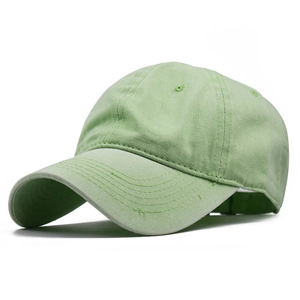 Detail view of the light green washed cotton baseball cap with a classic curved brim design