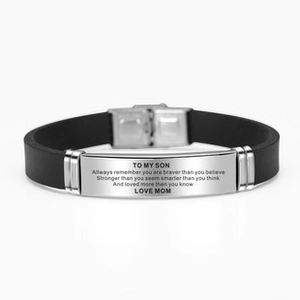 Macro detail of engraved inspirational quote for son on black silicone stainless bracelet