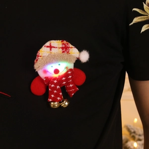 Luminous snowman Christmas brooch with red plaid hat and gold bell on black shirt