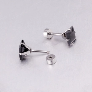 Detail view of black square stud earrings with 4-prong setting and secure screw backings