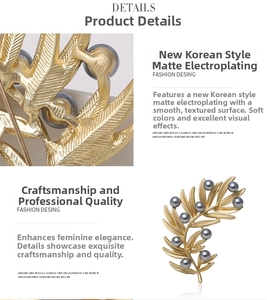 Detailed macro view of leaf brooch with matte gold finish and dark grey pearls