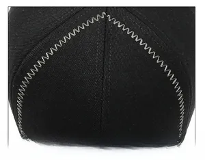 Detail of reinforced zigzag stitching and high-quality seam craft on black winter cap