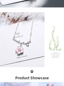 Macro detail of silver cherry blossom pendant with pink zircon and branch elements