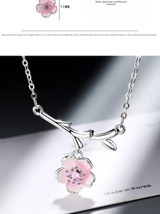 Macro shot of pink cherry blossom pendant with zircon stone and 11mm diameter detail