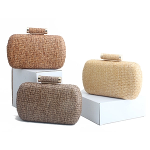 Handwoven straw clutch bags in beige and tan colors with elegant gold metal clasps