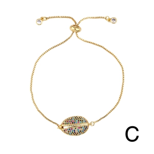 Detail of adjustable gold shell bracelet featuring colorful cubic zirconia pave setting