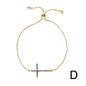 Adjustable gold shell bracelet with cross pendant and multi-colored cubic zirconia stones