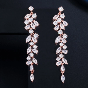 Close-up of rose gold leaf-shaped tassel earrings with sparkling zircon crystal pavé