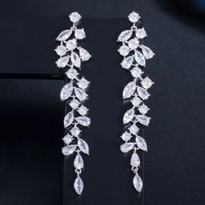 Detailed view of silver petal earrings with marquise cubic zirconia on black display stand