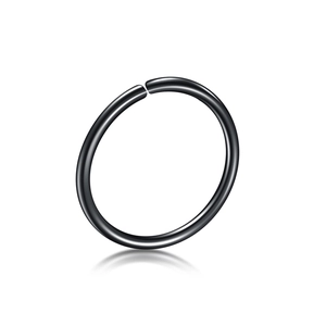Detail of polished black stainless steel nose ring with smooth finish on white background