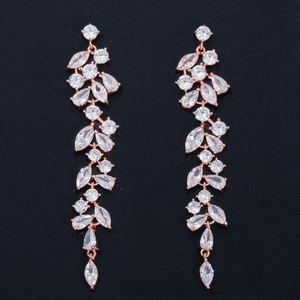 Elegant rose gold tassel earrings with zircon petals and crystals on dark textured background