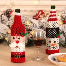 Detail of knitted Santa and Snowman wine bottle covers with festive holiday decorations