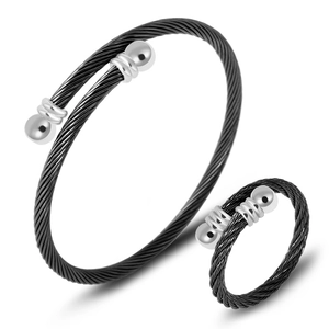 Detail shot of black cable wire spring bracelet and matching ring set in stainless steel
