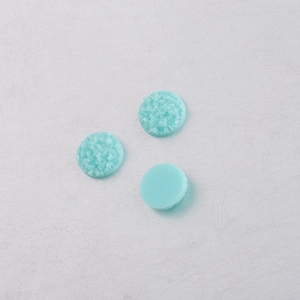 Macro detail of 8mm mint green resin flatback druzy crystals with sparkling textures