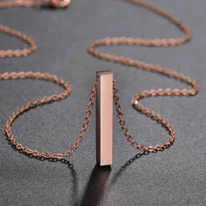 Macro shot of rose gold polished bar pendant on a stainless steel chain necklace
