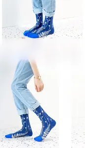 Detail showing dark blue mid-calf socks with white leaf pattern and reinforced toe
