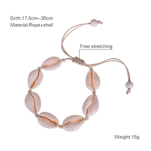 Detail of adjustable handmade woven shell bracelet with natural cream cowrie shells