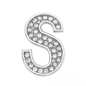Macro detail of silver S-shaped charm with crystal rhinestones for DIY jewelry making