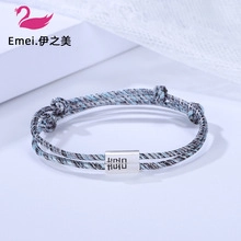 Macro shot of handcrafted woven rope bracelet with engraved silver metal buckle detail